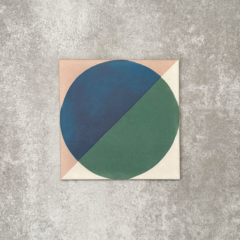 Single Abstract Ocean Patterned Tile in a 20x20cm format, featuring a bold geometric circular design with deep blue and rich green tones, framed by soft neutral corners. A contemporary patterned tile ideal for feature walls, floors or statement splashbacks.
