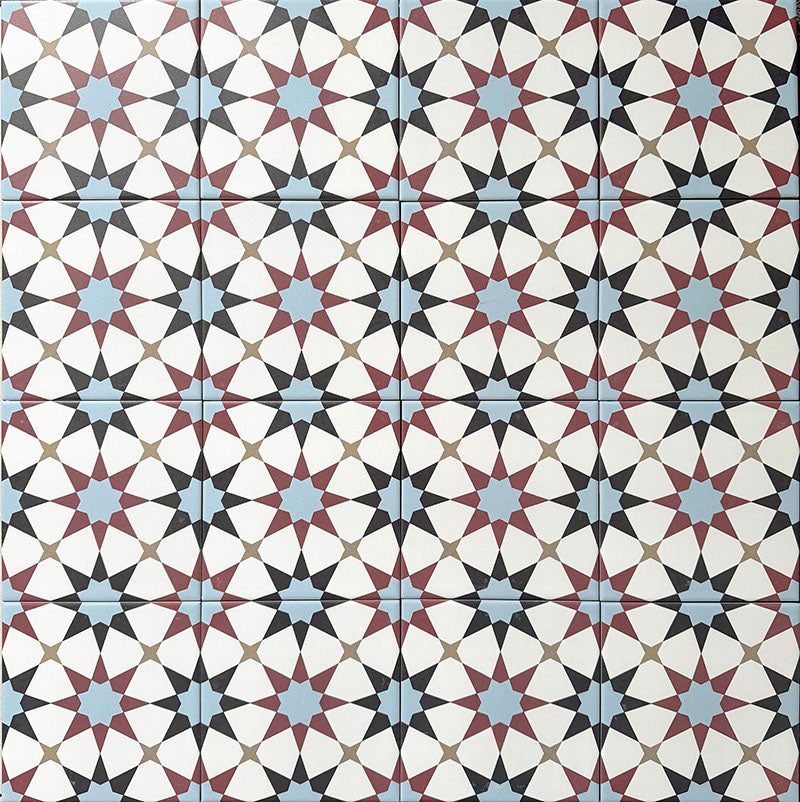 Agadir Atlas Mini Moroccan-style 15x15cm porcelain floor tiles laid in a repeating geometric star pattern, featuring a multicolour palette of soft blue, burgundy, black and cream.