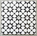 Agadir Black & White Moroccan-style 20x20cm porcelain tiles arranged as four tiles, showcasing a repeating geometric star pattern in black and white on a neutral background.