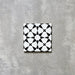 Agadir Black & White Mini Moroccan-style 15x15cm porcelain tile featuring a bold geometric star pattern in black and white, shown as a single tile on a neutral background.