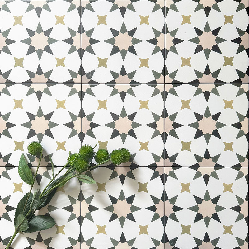 Group image of Agadir Natural Moroccan-style 20x20cm porcelain tiles, showcasing a repeating geometric star pattern in soft white with muted beige, olive and charcoal tones, styled with green foliage for a natural look.
