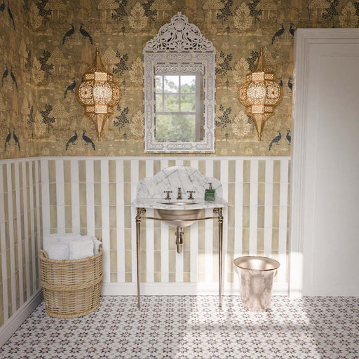 Bathroom featuring Agadir Natural 20x20cm Moroccan-style patterned floor tiles, with a repeating geometric star design in cream and brown, paired with striped wall tiles, decorative wallpaper and a marble washbasin.