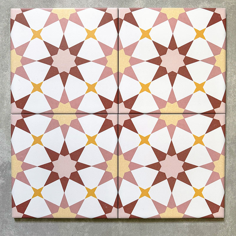 Agadir Springs Moroccan-style 20x20cm porcelain tiles arranged as four tiles, showcasing a repeating geometric star pattern in soft terracotta, blush pink, white and warm yellow tones on a neutral background.