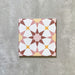 Agadir Springs Moroccan-style 20x20cm porcelain tile featuring a geometric star pattern in soft terracotta, blush pink, white and warm yellow tones, shown as a single tile on a neutral background.