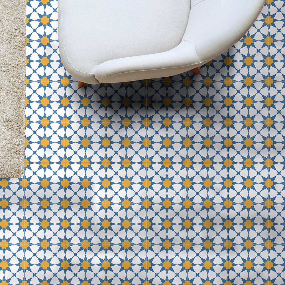Living room setting featuring Agadir Sun and Sky Moroccan-style 20x20cm porcelain floor tiles, showcasing a geometric star pattern in blue, white and warm yellow, styled with a contemporary sofa for a bright, inviting look.