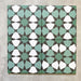 Four Agadir Verde Moroccan-style 20x20cm porcelain tiles laid together, forming a continuous geometric star pattern in soft green, white and charcoal tones.
