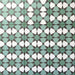 Group of Agadir Verde Moroccan-style 20x20cm porcelain tiles laid together, showcasing a repeating geometric star pattern in green, white and charcoal tones.