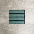 Alchemy Hunter Green 6.5×30cm ceramic wall tiles with a glossy green finish, shown as a group of rectangular tiles.