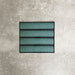 Alchemy Hunter Green 6.5×30cm ceramic wall tiles with a glossy green finish, shown as a group of rectangular tiles.