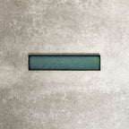 Alchemy Hunter Green 6.5×30cm ceramic wall tile with a glossy green finish.