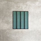 Alchemy Hunter Green 6.5×30cm ceramic wall tiles with a glossy green finish, shown as a group of rectangular tiles.