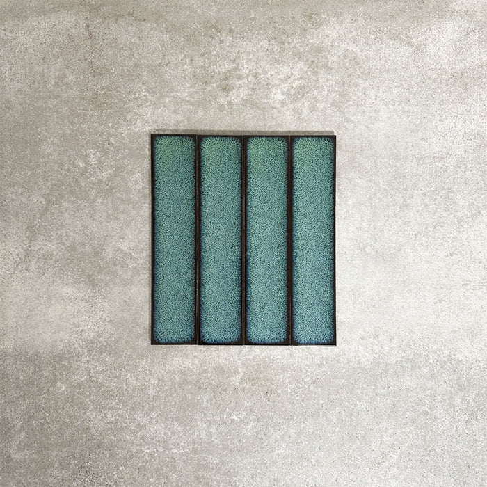 Alchemy Hunter Green 6.5×30cm ceramic wall tiles with a glossy green finish, shown as a group of rectangular tiles.