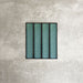 Alchemy Hunter Green 6.5×30cm ceramic wall tiles with a glossy green finish, shown as a group of rectangular tiles.