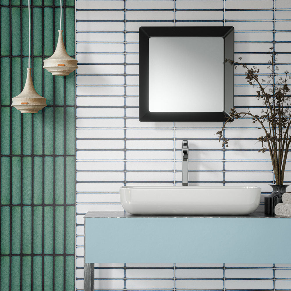 Alchemy Magma White 6.5cm x 30cm wall tiles installed horizontally around a modern bathroom vanity, paired with contrasting Alchemy Hunter Green tiles, a white countertop basin and contemporary black-framed mirror.
