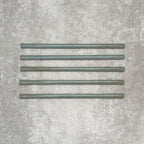 Allegra Celadon Green Gloss pencil bullnose border ceramic tiles in a 1.2 × 30cm format, shown as a set to highlight the soft green tones, glossy finish, smooth rounded edges and subtle handmade-style variation for decorative borders and trims.