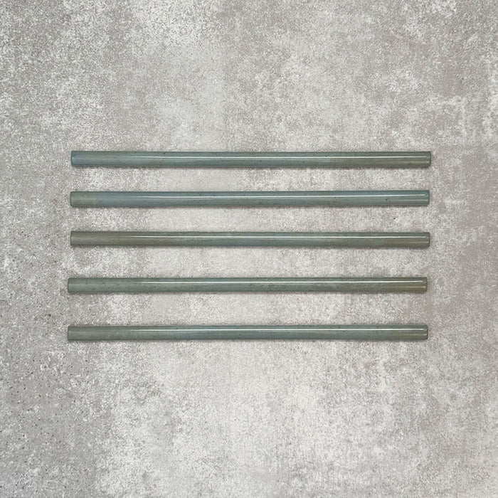 Allegra Celadon Green Gloss pencil bullnose border ceramic tiles in a 1.2 × 30cm format, shown as a set to highlight the soft green tones, glossy finish, smooth rounded edges and subtle handmade-style variation for decorative borders and trims.