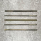 Five Allegra Daisy Green Gloss pencil bullnose border ceramic tiles in a 1.2 × 30cm format, laid horizontally to showcase the slim profile, glossy finish and subtle natural green tonal variations across the set.