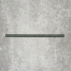 Allegra Green Gloss pencil bullnose border tile in a 1.2 × 30cm ceramic format, shown as a single piece laid horizontally to highlight its slim profile, rounded edge, deep green tone and smooth high-gloss finish on a neutral textured background.