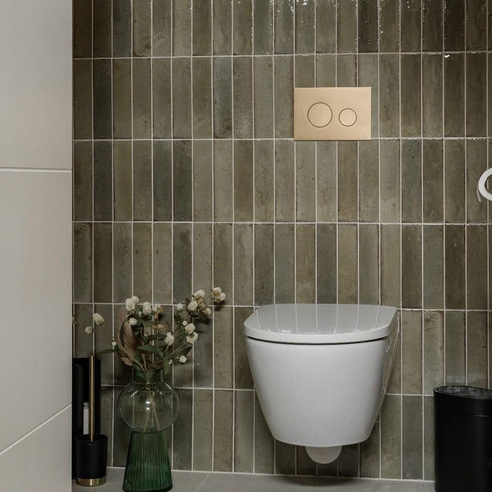 Bathroom wall featuring Allegra Sage Green Gloss Brick ceramic tiles in a 6 × 25cm format, laid vertically to create a refined, contemporary look with muted green tones, a glossy finish and subtle handmade-style variation.