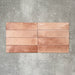 Allegra Tusk Pink Gloss Brick ceramic tiles in a 6 × 25cm format, laid horizontally to highlight the warm pink tones, glossy finish and subtle handmade-style variation.