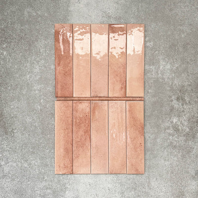 Allegra Tusk Pink Gloss pencil bullnose border ceramic tiles in a 1.2 × 30cm format, shown laid vertically to highlight the warm pink tones, glossy finish and subtle handmade-style variation, ideal for edging and decorative borders.