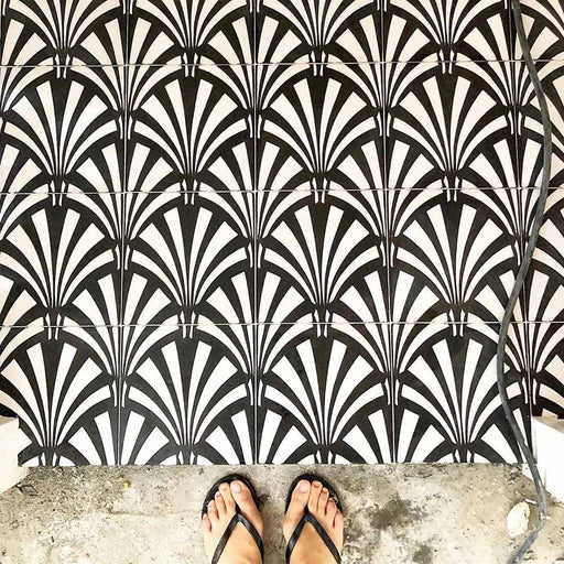 Floor featuring Almeria Casablanca Moroccan-style porcelain tiles in a bold black and white fan pattern, 20x20cm, creating a striking and decorative tiled surface.