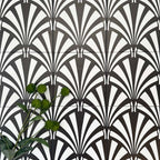 Almeria Casablanca Moroccan-style porcelain wall and floor tiles arranged in a repeating black and white fan pattern, 20x20cm, styled with greenery for a decorative display.