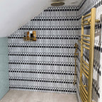 Shower area featuring Almeria Felis Moroccan-style porcelain wall tiles in a bold black and white geometric dot and line pattern, 20x20cm, paired with brass fixtures.