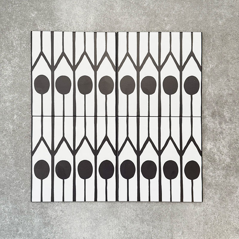 Four Almeria Felis Moroccan-style porcelain wall and floor tiles displayed together in a bold black and white geometric dot and line pattern, 20x20cm.