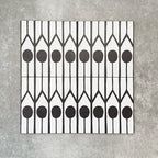 Four Almeria Felis Moroccan-style porcelain wall and floor tiles displayed together in a bold black and white geometric dot and line pattern, 20x20cm.