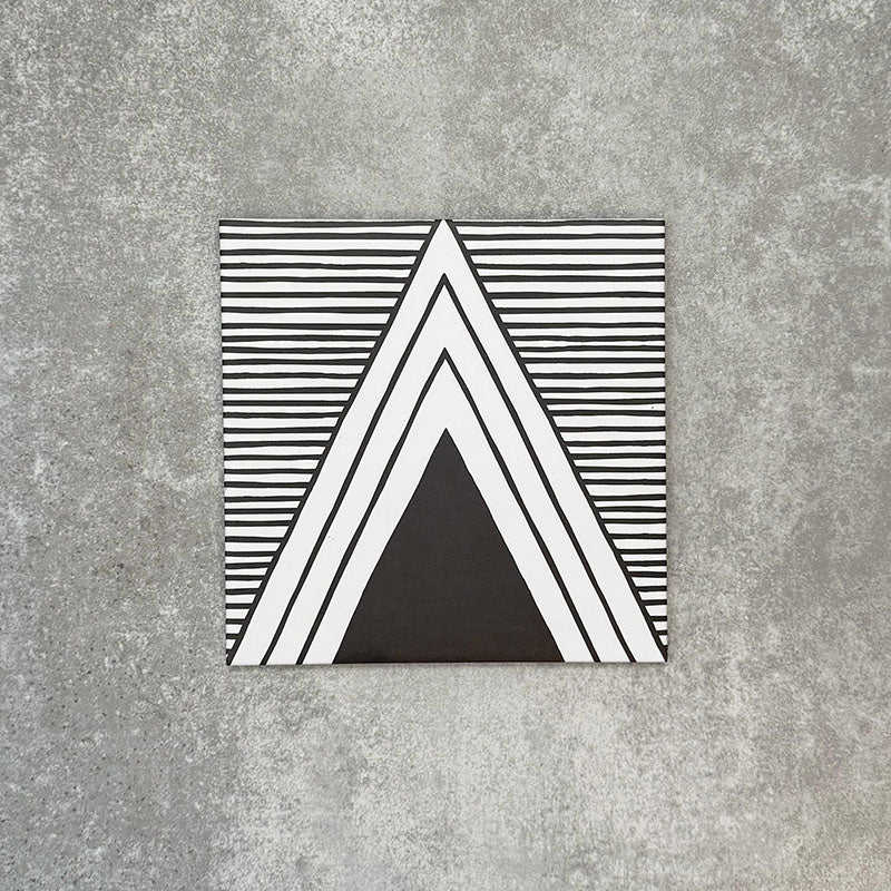 Single Almeria Giza Moroccan-style porcelain tile featuring a black and white geometric triangle design with fine linear detailing, 20x20cm, suitable for wall and floor use.