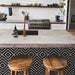 Kitchen island featuring Almeria Jilani Black Moroccan-style porcelain tiles in a striking white line geometric chevron pattern, 20x20cm, adding contrast and character to the space.
