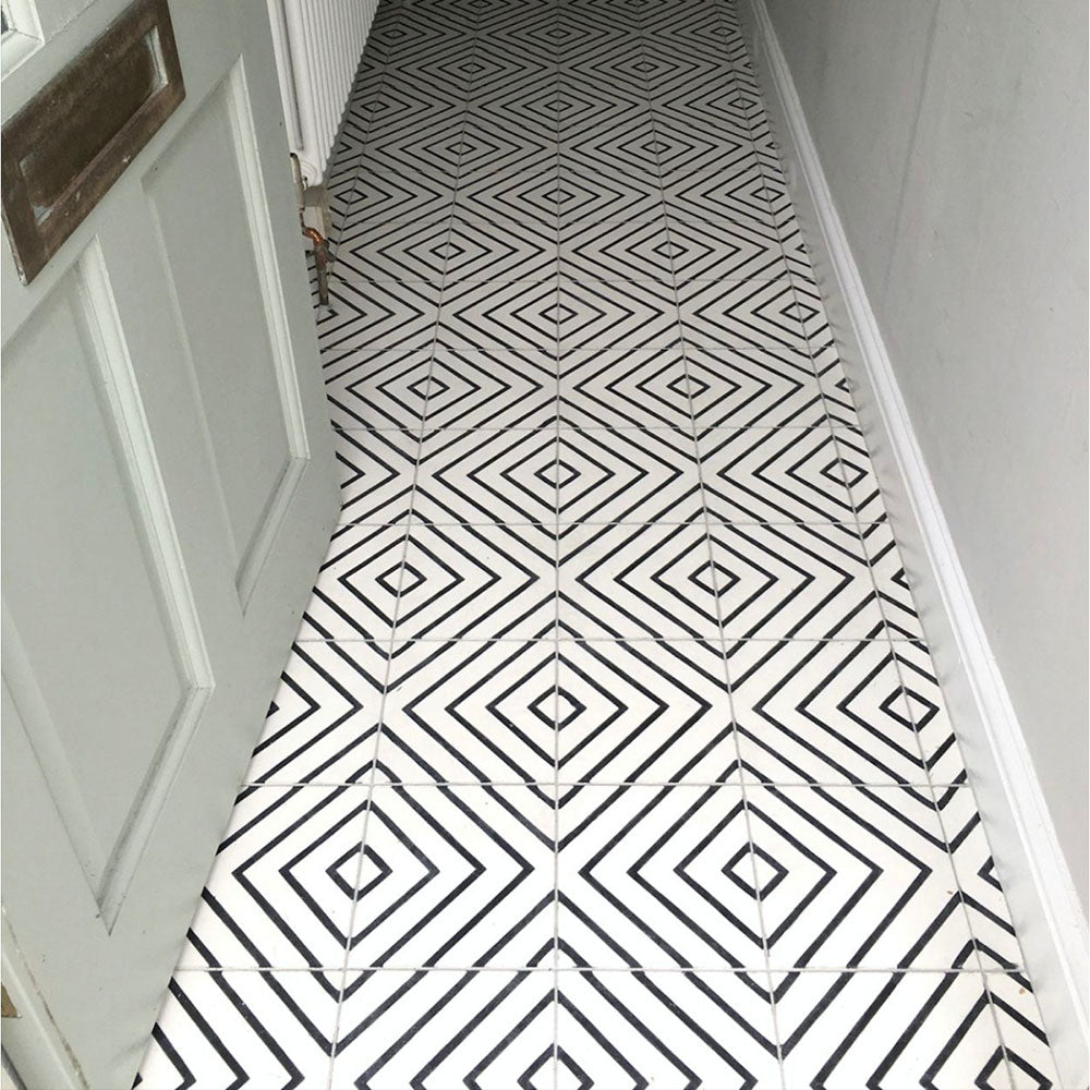 Hallway floor featuring Almeria Jilani White Moroccan-style porcelain tiles in a bold black line geometric diamond pattern, 20x20cm, creating a striking monochrome walkway.