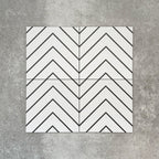 Four Almeria Jilani White Moroccan-style porcelain wall and floor tiles displayed together in a clean black line chevron pattern on a white base, 20x20cm.