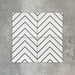 Four Almeria Jilani White Moroccan-style porcelain wall and floor tiles displayed together in a clean black line chevron pattern on a white base, 20x20cm.