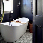 Bathroom featuring Almeria Palace Moroccan-style porcelain floor tiles in a refined black line geometric pattern, 20x20cm, paired with a freestanding bath and dark painted walls.