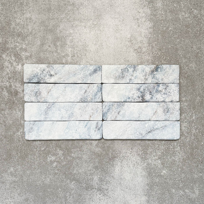 Product image of Amalfi Brick Azul Vintage Marble wall and floor tiles in a 5.4cm x 22cm format, showcasing soft blue and white marble effect detailing with subtle veining and tonal variation.