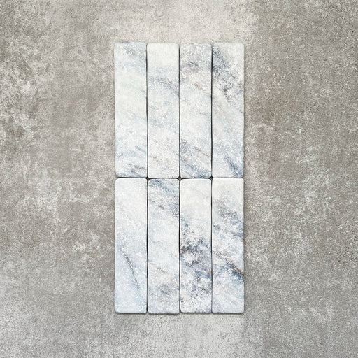 Product image of Amalfi Brick Azul Vintage Marble wall and floor tiles in a 5.4cm x 22cm format, showcasing soft blue and white marble effect detailing with subtle veining and tonal variation.
