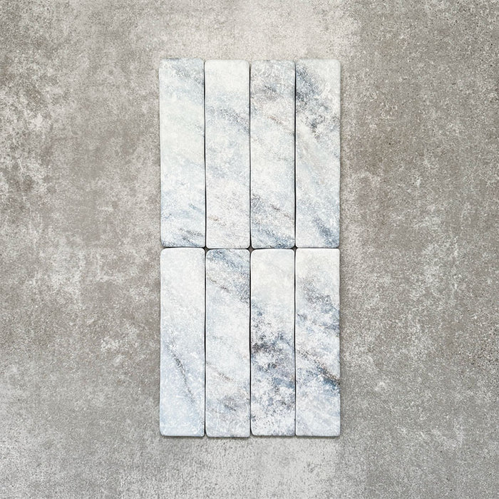 Product image of Amalfi Brick Azul Vintage Marble wall and floor tiles in a 5.4cm x 22cm format, showcasing soft blue and white marble effect detailing with subtle veining and tonal variation.