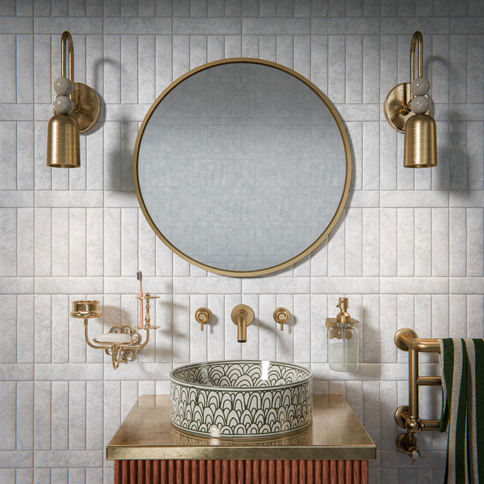 Bathroom featuring Amalfi Brick Carrara Vintage Marble 5.4x22cm wall and floor tiles, installed in a brick layout, showcasing soft white and grey tones, paired with brass fittings, textured details, and a refined, classic contemporary finish.