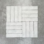 Product image of Amalfi Brick Carrara Vintage Marble wall and floor tiles in a 5.4cm x 22cm format, arranged in a basketweave pattern, showcasing a soft white marble effect surface with subtle tonal variation.