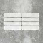 Product image of Amalfi Brick Carrara Vintage Marble wall and floor tiles in a 5.4cm x 22cm format, showcasing a soft white marble effect surface with subtle tonal variation.