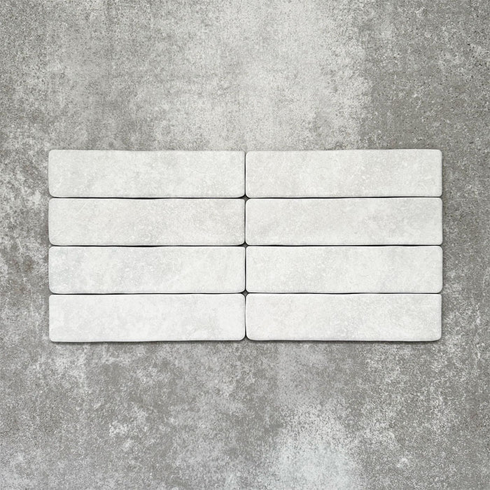 Product image of Amalfi Brick Carrara Vintage Marble wall and floor tiles in a 5.4cm x 22cm format, showcasing a soft white marble effect surface with subtle tonal variation.