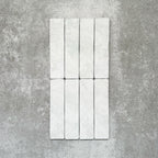 Product image of Amalfi Brick Carrara Vintage Marble wall and floor tiles in a 5.4cm x 22cm format, showcasing a soft white marble effect surface with subtle tonal variation.