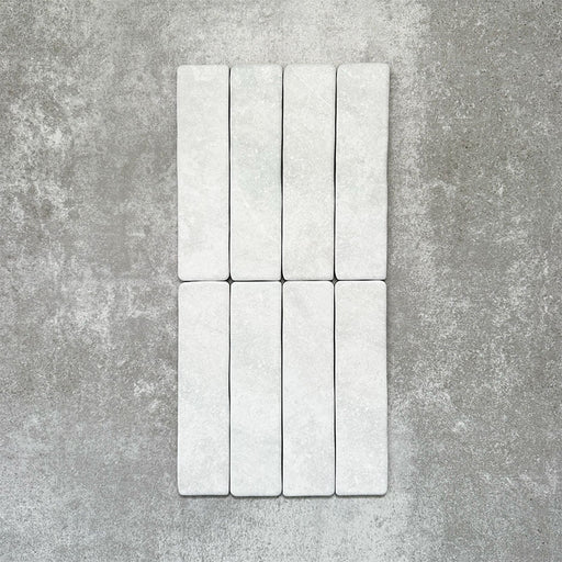 Product image of Amalfi Brick Carrara Vintage Marble wall and floor tiles in a 5.4cm x 22cm format, showcasing a soft white marble effect surface with subtle tonal variation.