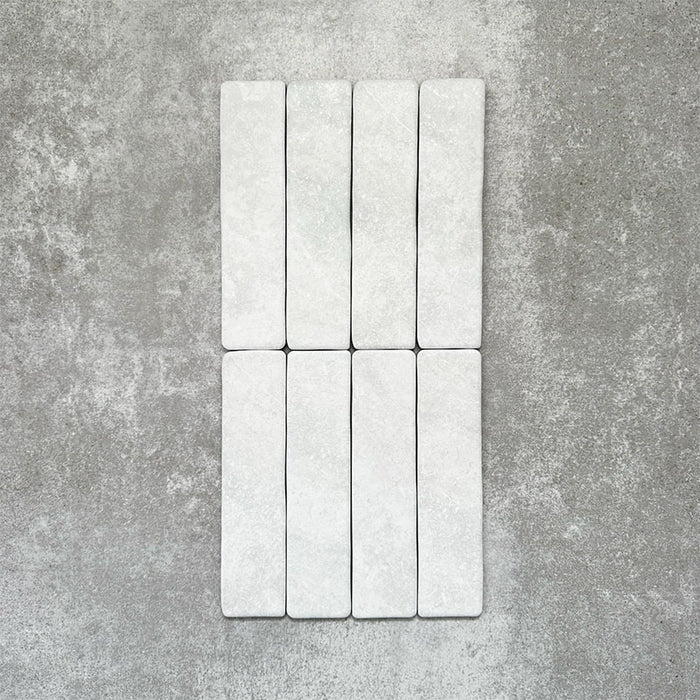 Product image of Amalfi Brick Carrara Vintage Marble wall and floor tiles in a 5.4cm x 22cm format, showcasing a soft white marble effect surface with subtle tonal variation.