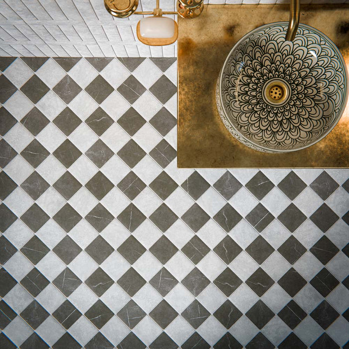 Bathroom featuring Amalfi Square Carrara Vintage Marble 11x11cm wall and floor tiles, laid in a diagonal chequerboard pattern, showcasing soft white and grey tones, paired with brass fittings, a fluted vanity unit, and a classic contemporary finish.