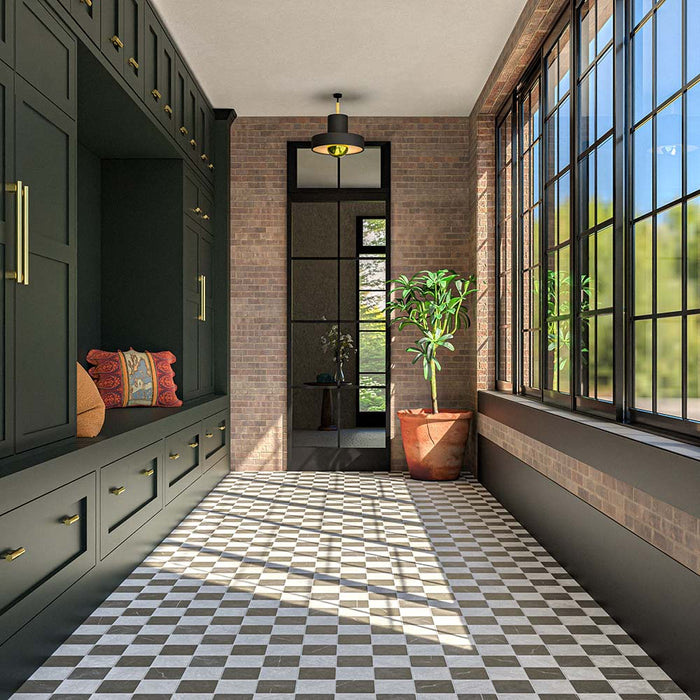 Hallway featuring Amalfi Carrara Square 11cm x 11cm vintage marble wall and floor tiles in a chequerboard design, paired with dark green cabinetry, exposed brick walls and black-framed windows.