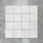 Product image of Amalfi Square Carrara Vintage Marble wall and floor tiles in an 11cm x 11cm format, featuring a soft white marble effect surface with subtle tonal variation and gently rounded edges.