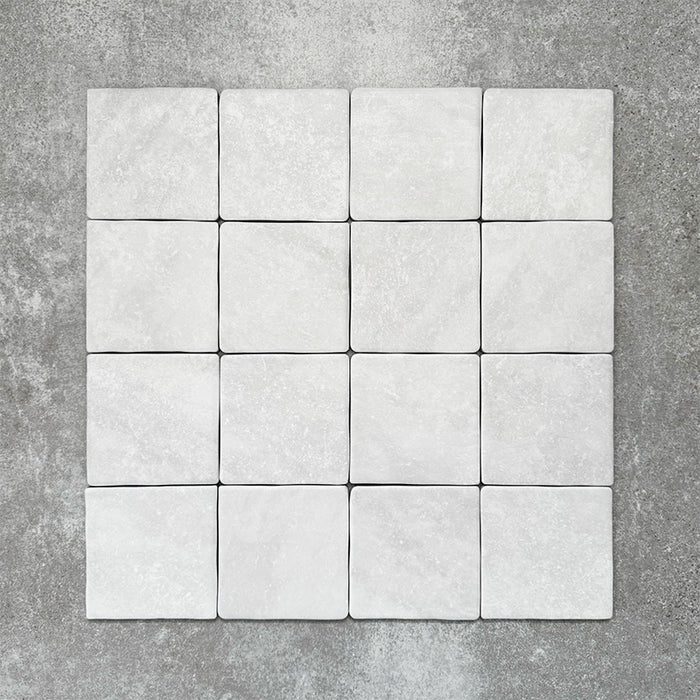 Product image of Amalfi Square Carrara Vintage Marble wall and floor tiles in an 11cm x 11cm format, featuring a soft white marble effect surface with subtle tonal variation and gently rounded edges.